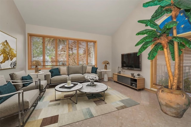 living room featuring high vaulted ceiling and light tile patterned floors