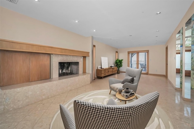 living room featuring recessed lighting, baseboards, and a premium fireplace