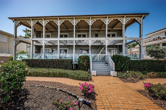 rear view of property featuring stairway