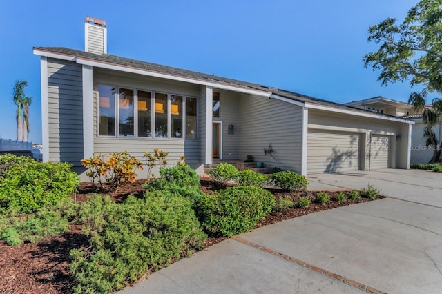 526 Belle Isle Ave, Belleair Beach, FL 33786 - ranch-style home featuring an attached garage, driveway, and a chimney