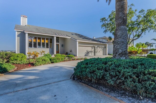 526 Belle Isle Ave, Belleair Beach, FL 33786 - single story home featuring an attached garage, a chimney, and concrete driveway