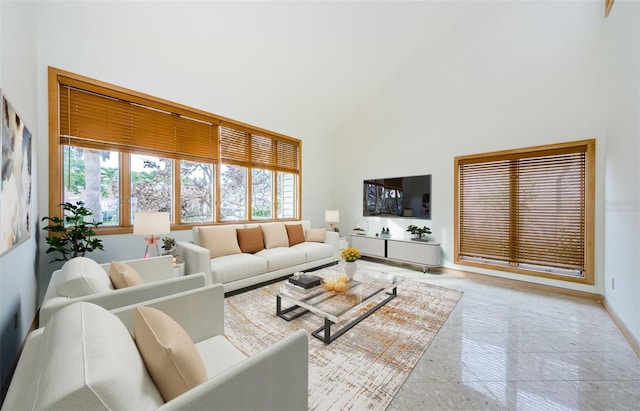 526 Belle Isle Ave, Belleair Beach, FL 33786 - living area featuring high vaulted ceiling, baseboards, and plenty of natural light