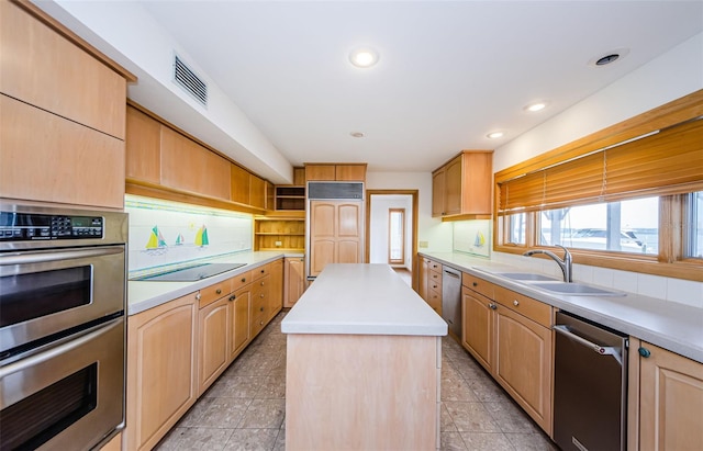 526 Belle Isle Ave, Belleair Beach, FL 33786 - kitchen with a sink, stainless steel appliances, light countertops, visible vents, and a kitchen island