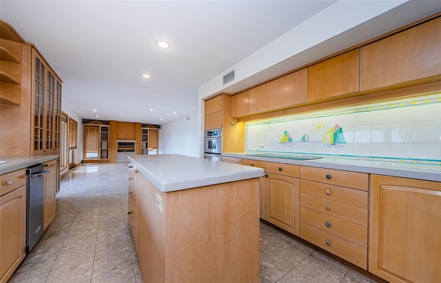 526 Belle Isle Ave, Belleair Beach, FL 33786 - kitchen with a center island, stainless steel appliances, visible vents, and light countertops