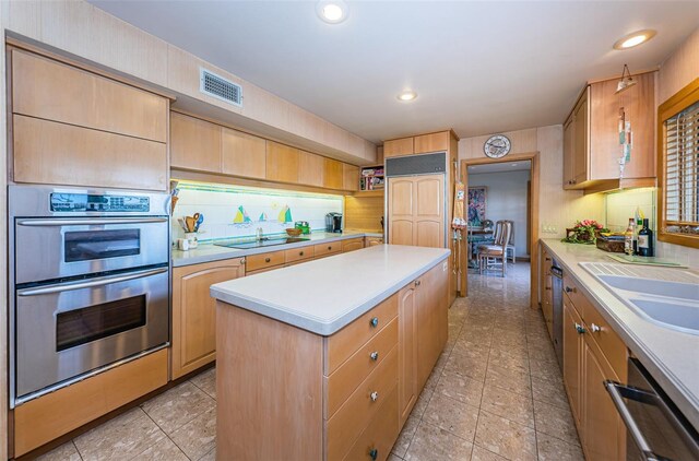 526 Belle Isle Ave, Belleair Beach, FL 33786 - kitchen with light countertops, double oven, dishwashing machine, and a center island