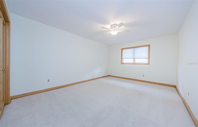 526 Belle Isle Ave, Belleair Beach, FL 33786 - spare room featuring baseboards, light colored carpet, and ceiling fan