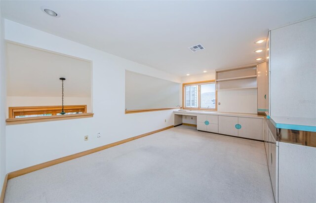 526 Belle Isle Ave, Belleair Beach, FL 33786 - kitchen with built in study area, light carpet, baseboards, visible vents, and recessed lighting