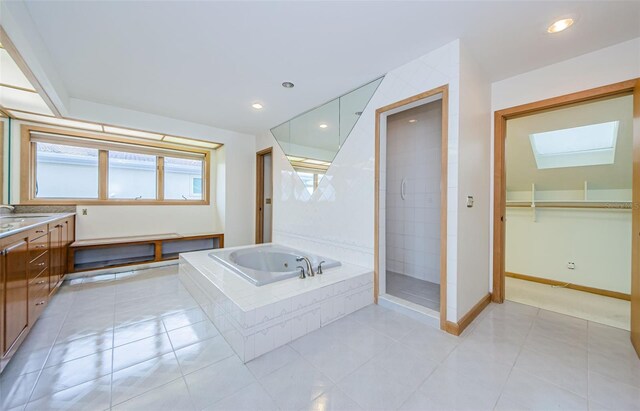 526 Belle Isle Ave, Belleair Beach, FL 33786 - full bathroom with a stall shower, a bath, a skylight, vanity, and baseboards