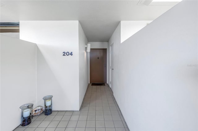 hallway featuring light tile patterned floors