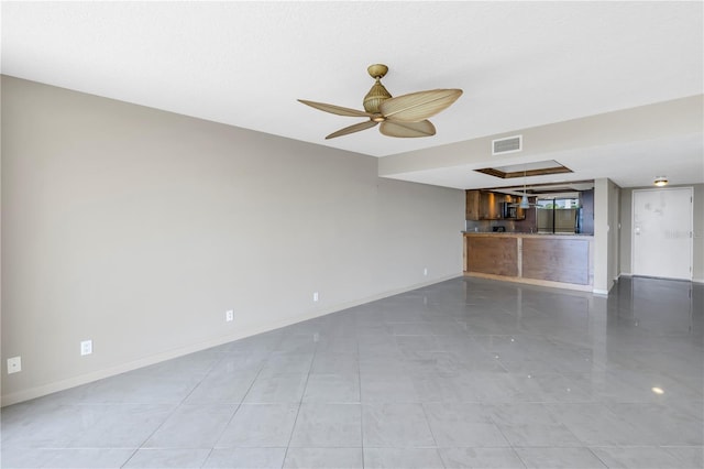 unfurnished living room with ceiling fan and light tile patterned flooring