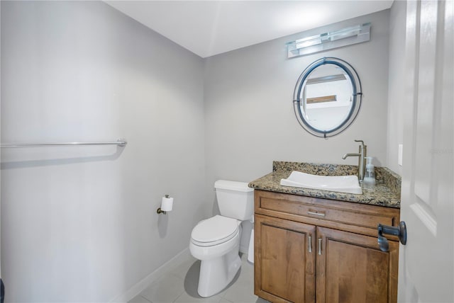 bathroom featuring tile patterned flooring, vanity, and toilet