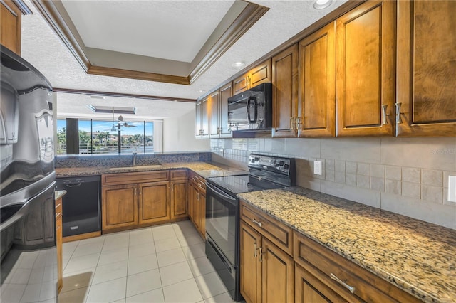 kitchen with stone counters, black appliances, sink, light tile patterned floors, and a textured ceiling