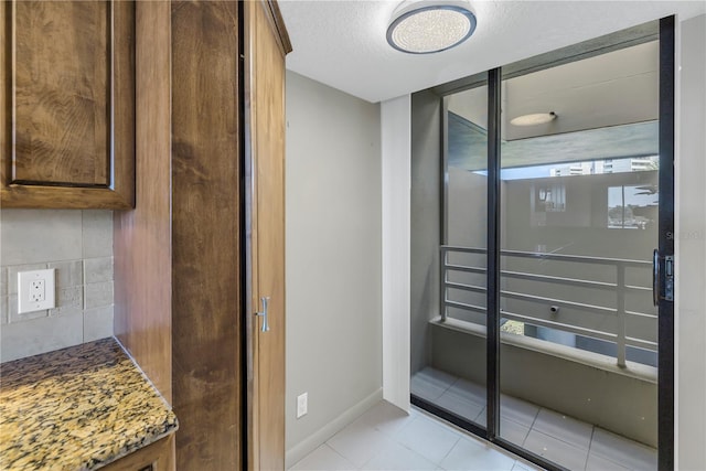 bathroom featuring tile patterned flooring and a textured ceiling