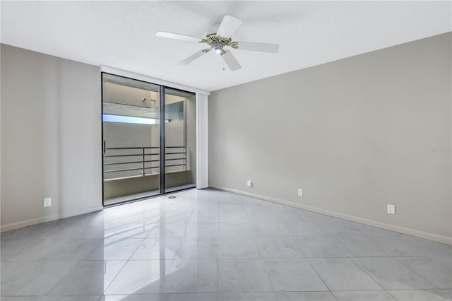 tiled empty room with a textured ceiling and ceiling fan