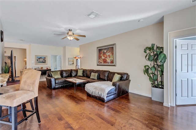 living room with dark hardwood / wood-style floors and ceiling fan