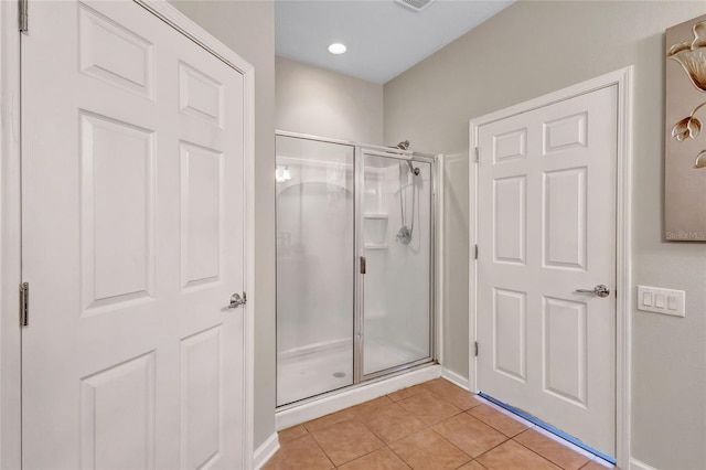 bathroom with tile patterned floors and walk in shower