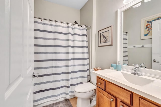 bathroom featuring a shower with curtain, vanity, and toilet