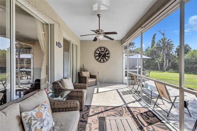 sunroom featuring ceiling fan