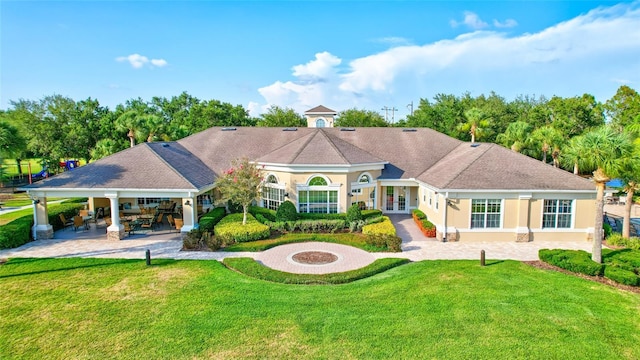 back of house with a fire pit, a patio area, a yard, and french doors