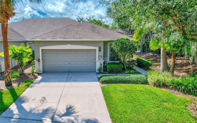 single story home featuring a shingled roof, driveway, an attached garage, and stucco siding