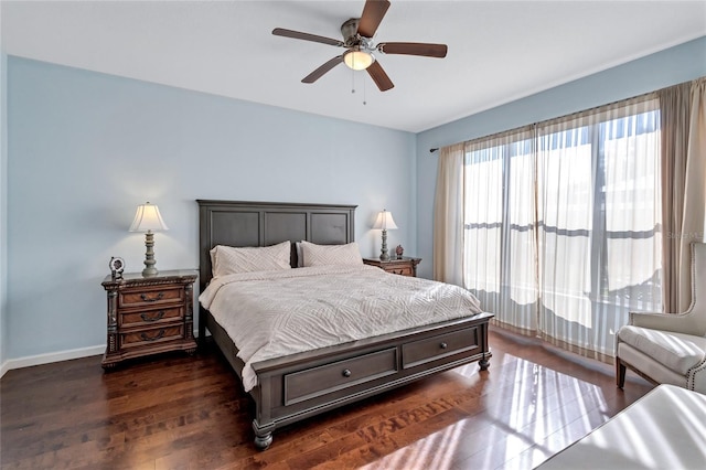 bedroom with baseboards, dark wood finished floors, and a ceiling fan