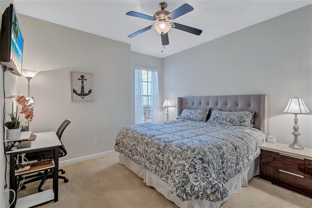 bedroom with light colored carpet, ceiling fan, and baseboards