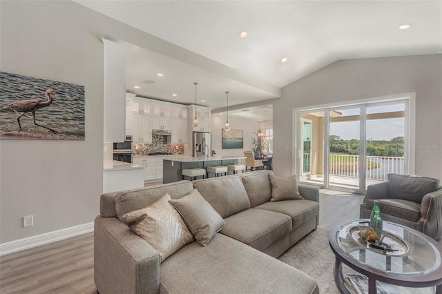 living room with light wood-type flooring and lofted ceiling