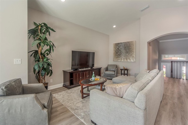 living room with light hardwood / wood-style flooring and lofted ceiling