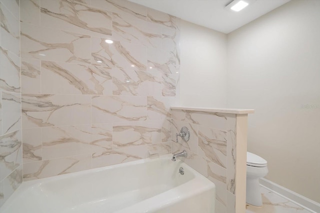 full bathroom with a bathtub, marble finish floor, baseboards, and toilet