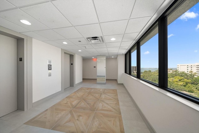 corridor with recessed lighting, elevator, visible vents, and baseboards