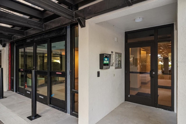 entrance to property featuring stucco siding