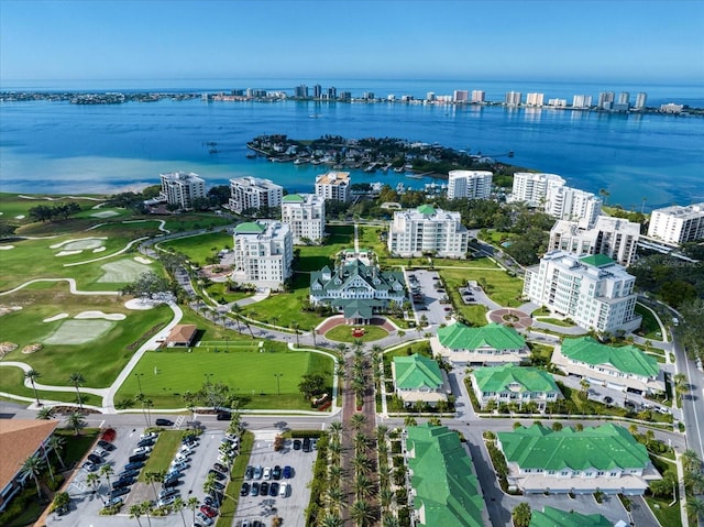 birds eye view of property featuring a water view and a city view