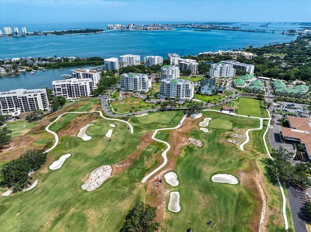 bird's eye view with view of golf course, a water view, and a city view