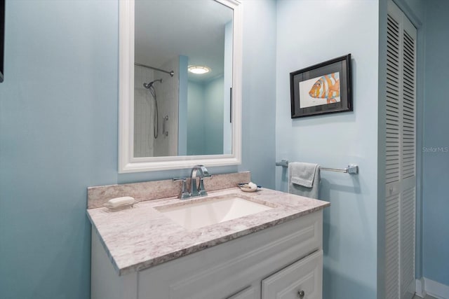 bathroom with a closet and vanity