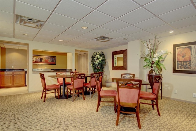 dining room with carpet, a paneled ceiling, recessed lighting, visible vents, and baseboards