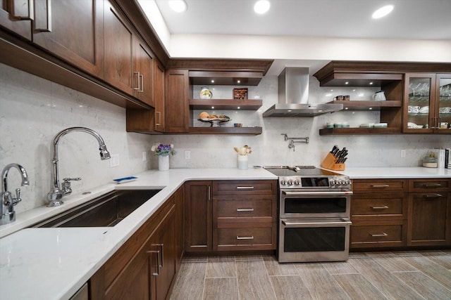 kitchen featuring range with two ovens, a sink, extractor fan, open shelves, and backsplash