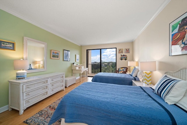 bedroom with light wood-type flooring, access to outside, ornamental molding, and baseboards