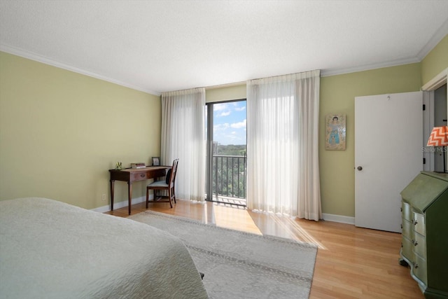 bedroom featuring access to outside, ornamental molding, light wood-type flooring, and baseboards