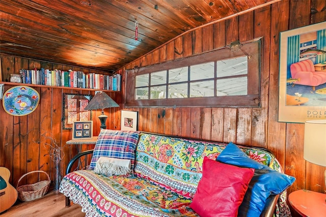 sitting room with wood walls, wood ceiling, lofted ceiling, and wood-type flooring