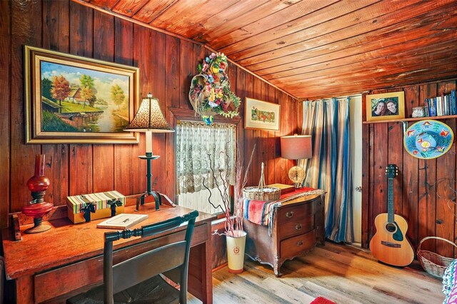 interior space featuring lofted ceiling, wood walls, light wood-type flooring, and wooden ceiling