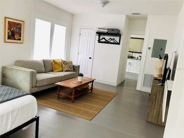 living room with electric panel and dark hardwood / wood-style floors