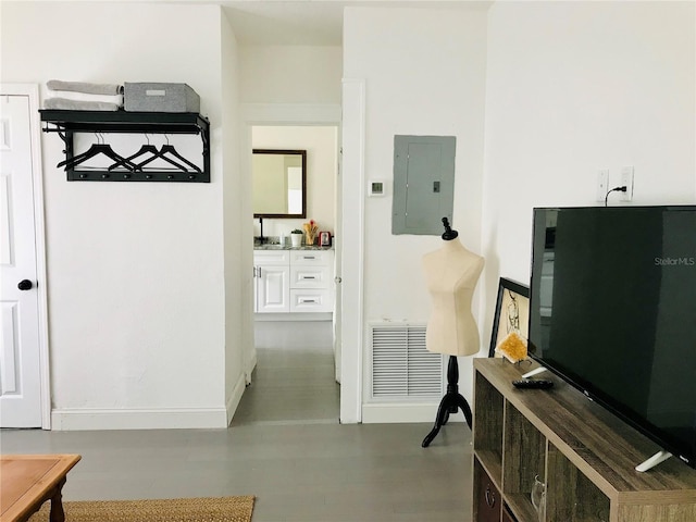 corridor with electric panel and concrete floors