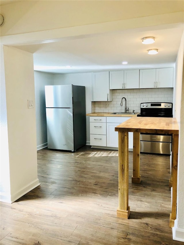 kitchen featuring white cabinets, sink, light wood-type flooring, and stainless steel appliances