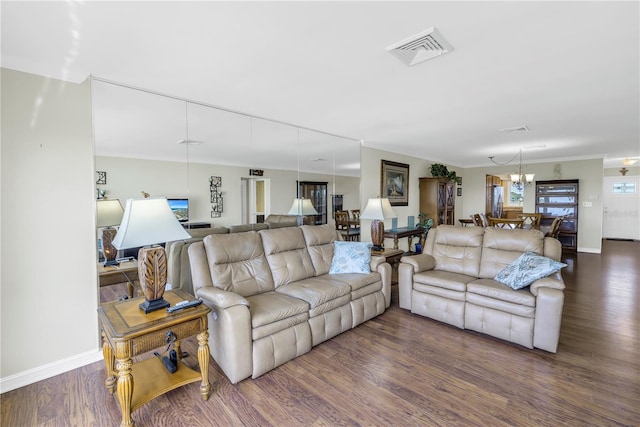 living room with dark hardwood / wood-style flooring and ornamental molding