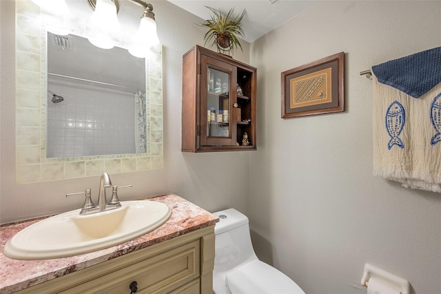 bathroom with curtained shower, vanity, and toilet