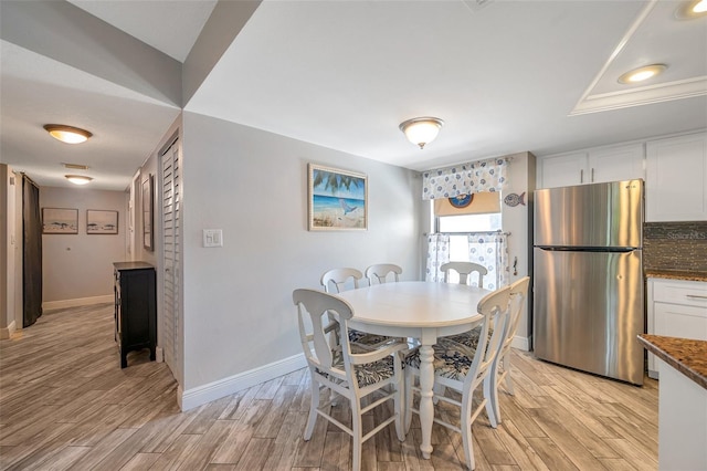 dining space with light wood-type flooring