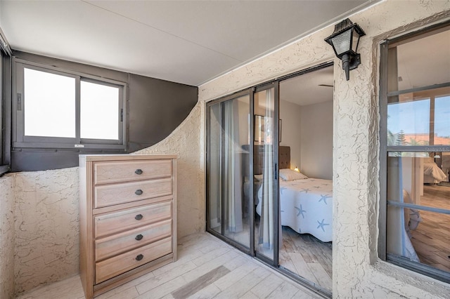 bedroom with light hardwood / wood-style flooring and a closet