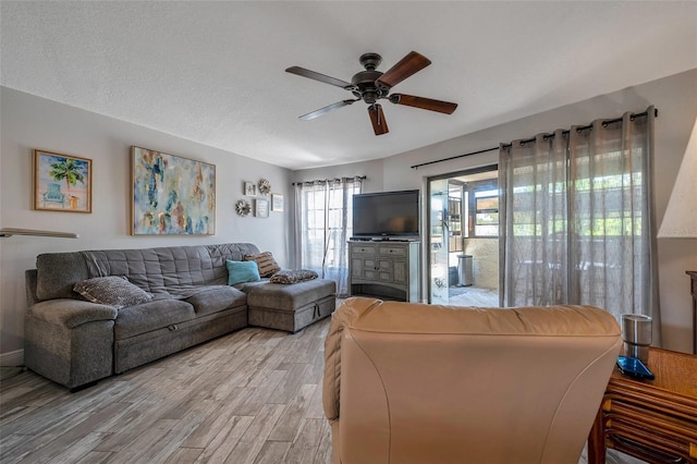 living room featuring light hardwood / wood-style floors and ceiling fan