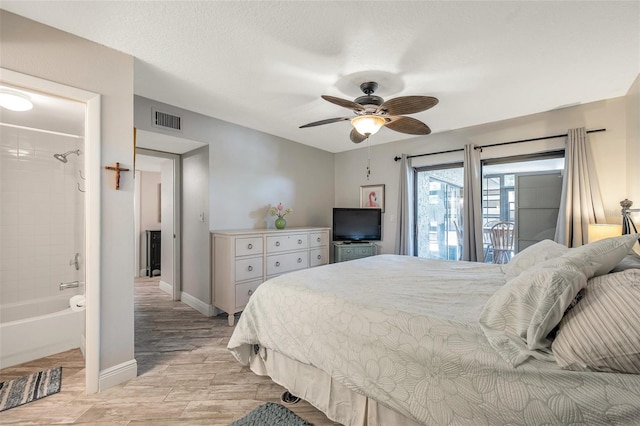 bedroom featuring access to outside, ensuite bathroom, ceiling fan, and light hardwood / wood-style floors