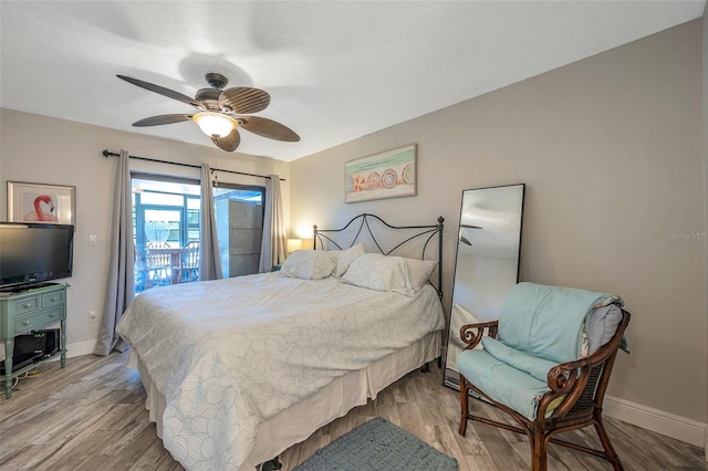 bedroom featuring access to outside, ceiling fan, and light hardwood / wood-style flooring